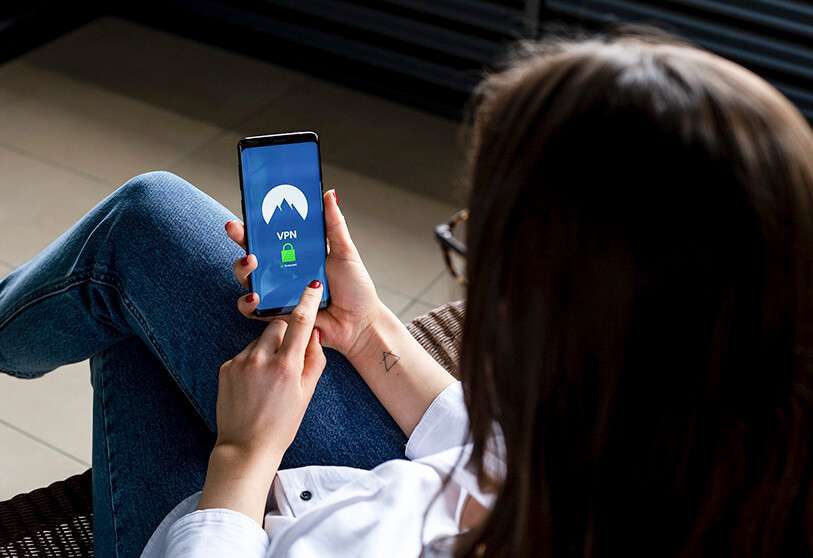 Ciberseguridad; mujer sostiene un móvil