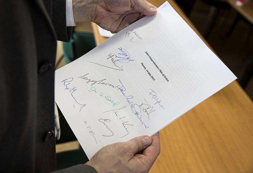 REUTERS/THOMAS IMO - Martin Schaefer, press officer of the German Ministry of Foreign Affairs holds a signed copy of the Joint Comprehensive Action Plan concerning Iran's nuclear programme, shown in Vienna, Austria, on 14 July 2015