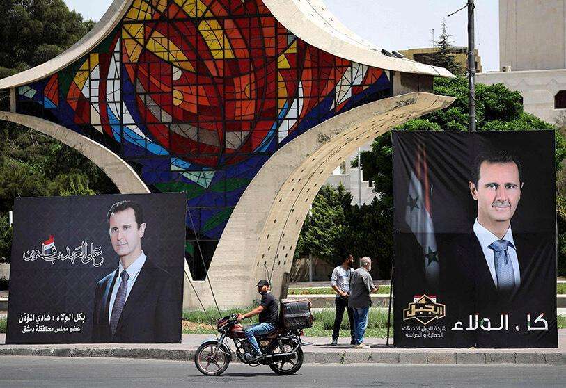AFP/ LOUAI BESHARA - Retratos del presidente Bashar al-Assad en la plaza de Umawiyin en la capital de Siria, Damasco, el 3 de mayo de 2021, antes de las elecciones presidenciales de este mes