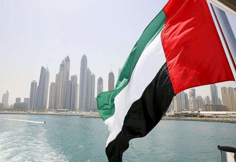 HOTO/REUTERS - The flag flies over a ship at the marina in Dubai, United Arab Emirates.