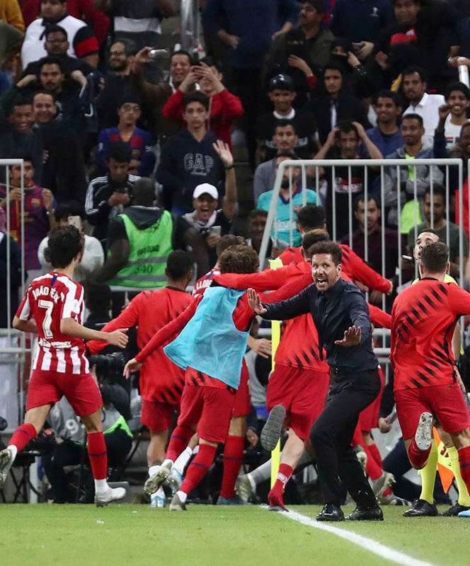 Ángel Correa, del Atlético de Madrid, celebra su tercer gol con sus compañeros y el entrenador Diego Simeone
