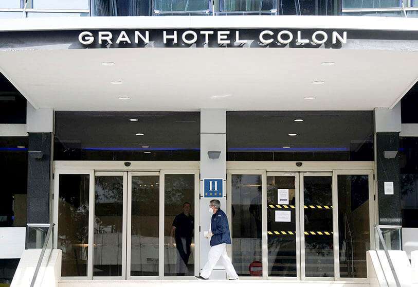 Un trabajador de la salud con una mascarilla entra en el Gran Hotel Colón de Madrid, el 19 de marzo de 2020
