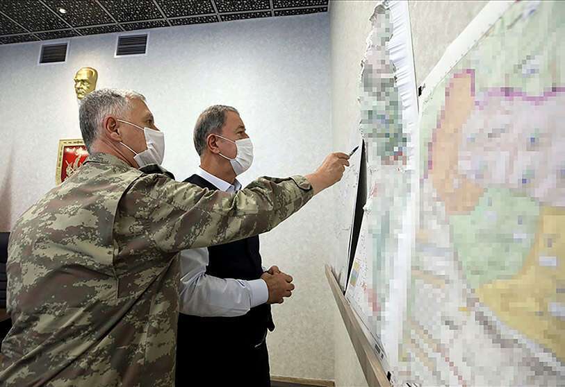 Imagen de archivo facilitada por la Oficina de Prensa del Ministerio de Defensa turco el 17 de junio de 2020, muestra al ministro de Defensa turco, Hulusi Akar (Der), mirando un mapa con miembros del Mando de las Fuerzas Armadas turcas durante una reunión en el Centro de Control del Mando del Ejército en Ankara durante la operación militar apodada "Claw-Tiger" el 17 de junio de 2020