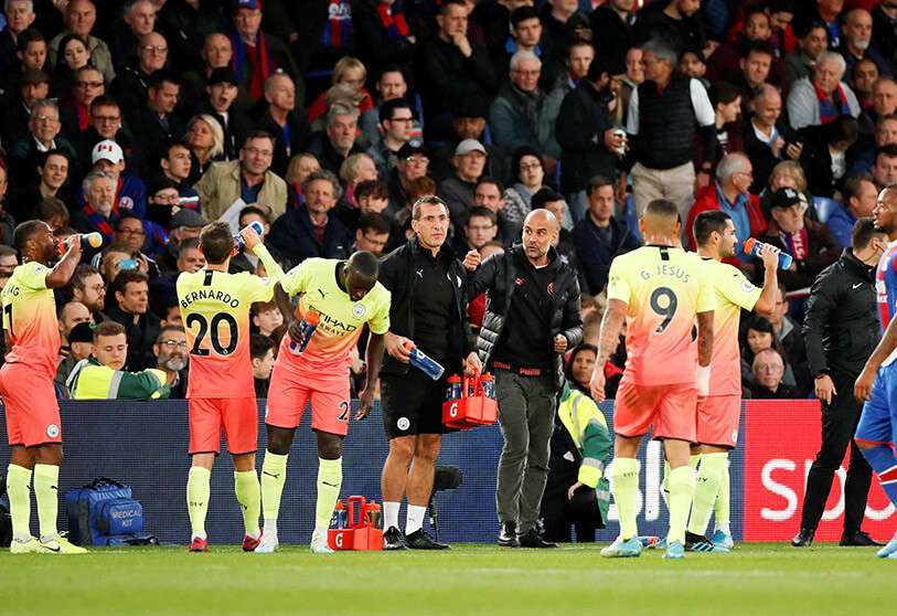 Los jugadores del Manchester City durante una pausa en el partido ante el Crystal Palace junto al entrenador Pep Guardiola
