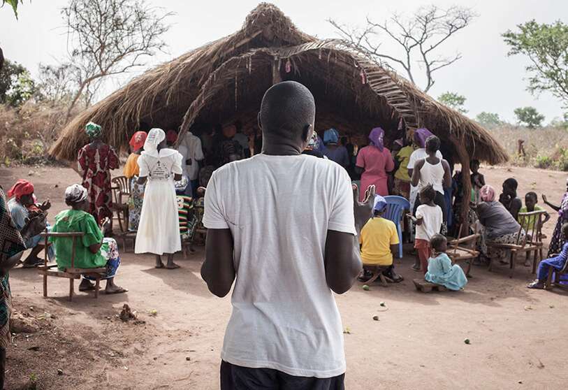 Desplazados de Sudán del Sur rezan frente a la iglesia del campamento de refugiados de Obo