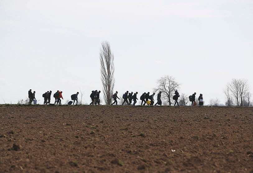 AP/DARKO BANDIC - Migrants walk near the border gate of Pazarkule in Edirne on the Greek-Turkish border on Monday 2 March 2020