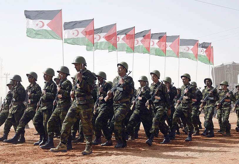 AFP/FAROUK BATICHE - Members of the Sahrawi People's Liberation Army parade with the flags of the Polisario Front during a ceremony commemorating the 40th anniversary of the proclamation of the Sahrawi Arab Democratic Republic (SADR) in the disputed territory of Western Sahara.