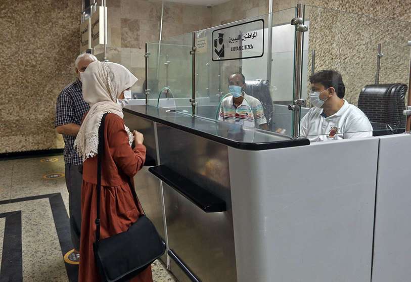 Pasajeros en el aeropuerto internacional de Mitiga después de que algunas compañías aéreas reanudaran sus vuelos, en la capital libia, Trípoli, el 11 de agosto de 2020, en medio de la crisis de la pandemia del coronavirus. AFP/MAHMUD TURKIA
