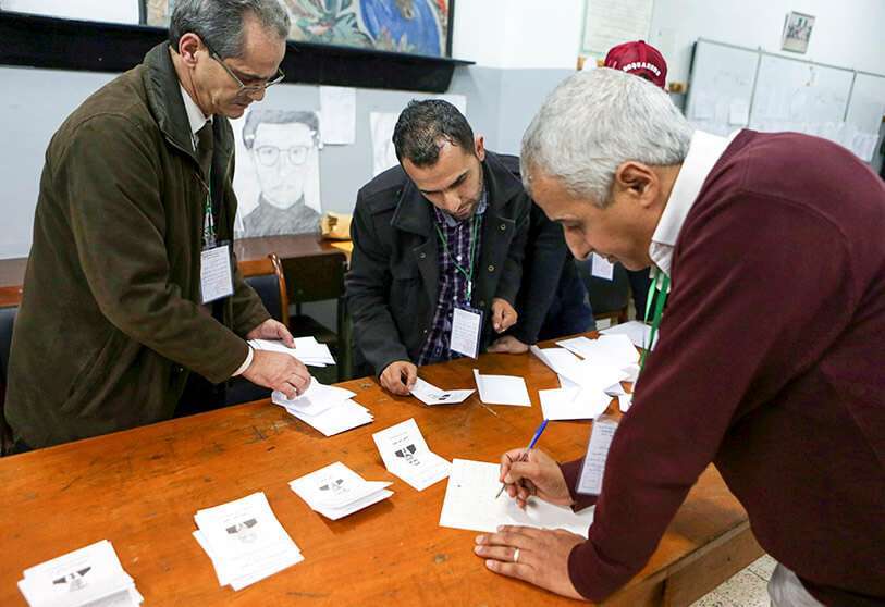 Los trabajadores electorales cuentan las papeletas de voto después de las elecciones presidenciales en un colegio electoral