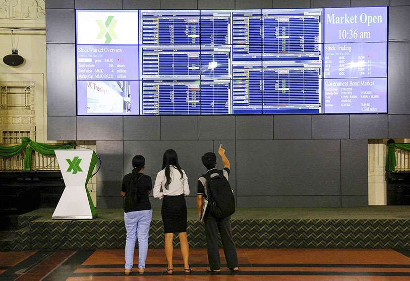 Cours et indice boursier affichés sur un grand écran vidéo à la Bourse de Yangon, le 20 mars 2020
