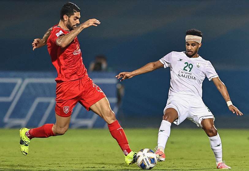 El centrocampista del Duhail, Ali Karimi (izq.), disputa el balón con el delantero del Ahli, Abdulrahman Ghareeb, durante el partido del grupo C de la Liga de Campeones de la AFC entre el Al-Duhail qatarí y el Al-Ahli saudí, el 30 de abril de 2021, en el estadio de la ciudad deportiva Rey Abdullah, en la ciudad saudí de Jeddah