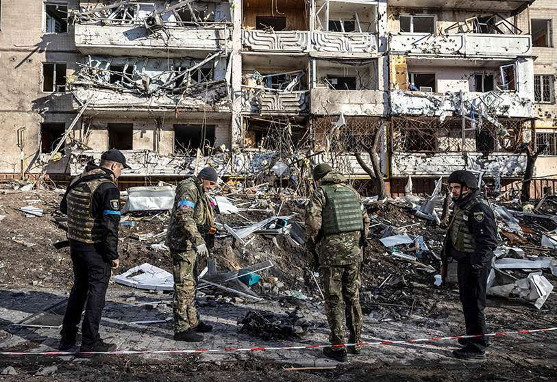Soldados ucranianos inspeccionan los escombros de un edificio de apartamentos destruido en Kiev el 15 de marzo de 2022 AFP/FADEL SENNA